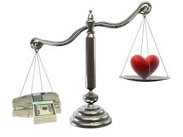 heart and cash on scales